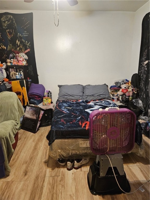 bedroom with hardwood / wood-style floors and ceiling fan