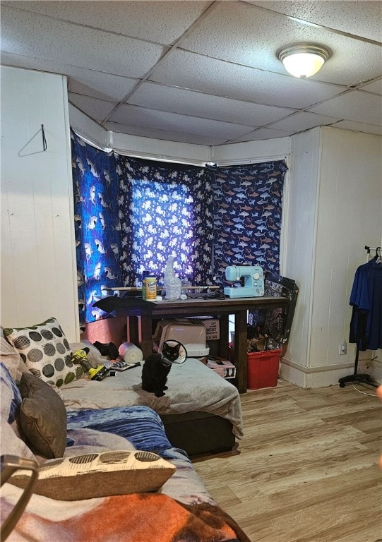 bedroom featuring a paneled ceiling and wood-type flooring