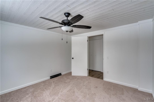 unfurnished bedroom featuring ceiling fan, baseboards, and carpet flooring