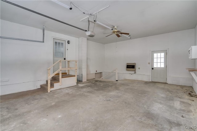 garage with a garage door opener and heating unit