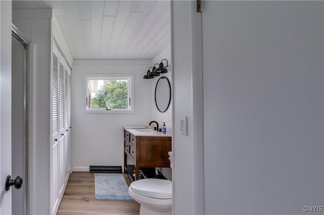 full bathroom with toilet, an enclosed shower, wood finished floors, and vanity