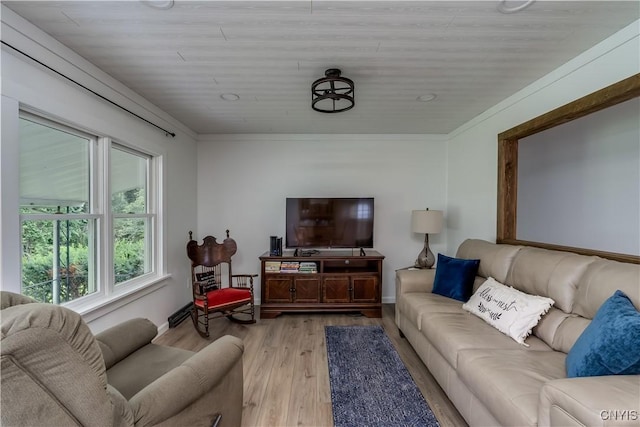 living area featuring light wood-style flooring and ornamental molding