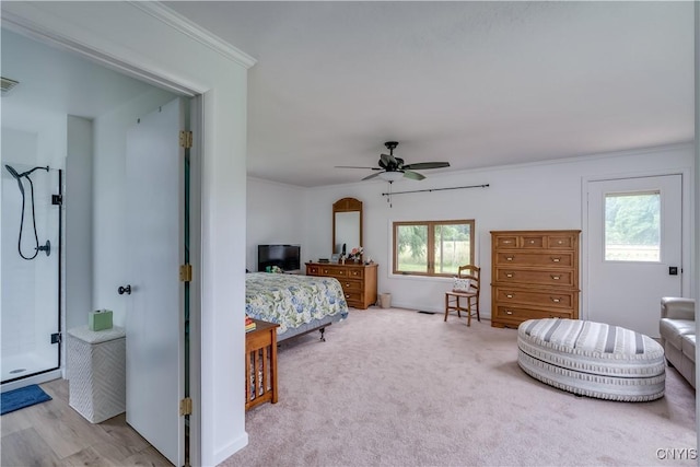 bedroom featuring ornamental molding, a ceiling fan, visible vents, and light colored carpet