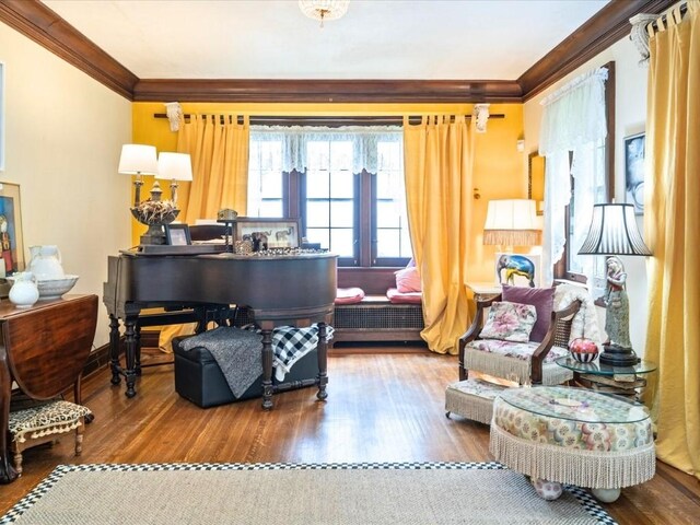 living area featuring crown molding and wood-type flooring