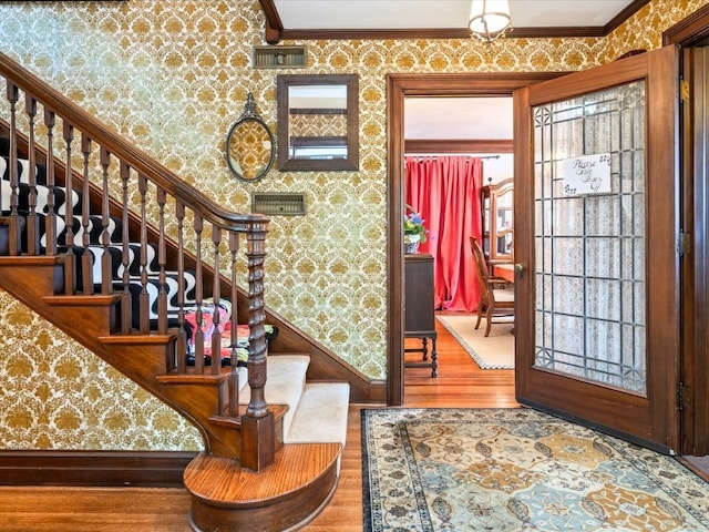 entrance foyer with hardwood / wood-style flooring and ornamental molding