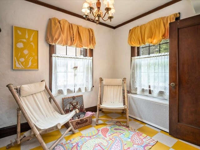 living area featuring radiator, a notable chandelier, and ornamental molding