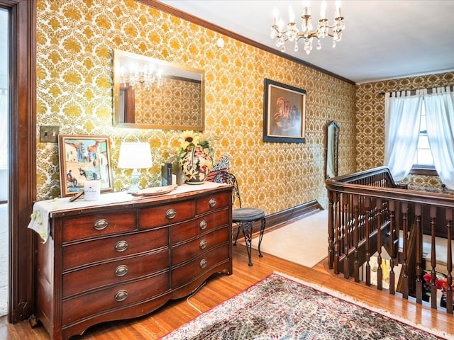 bedroom with crown molding, a chandelier, and light hardwood / wood-style floors