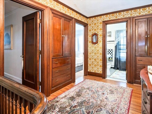 interior space featuring light wood-type flooring and ornamental molding