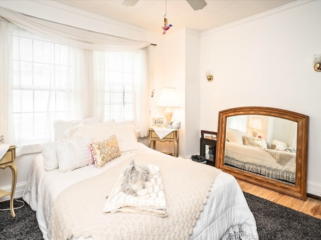 bedroom with ceiling fan, crown molding, and light wood-type flooring