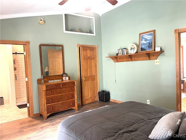 bedroom with ceiling fan, wood-type flooring, and ensuite bath