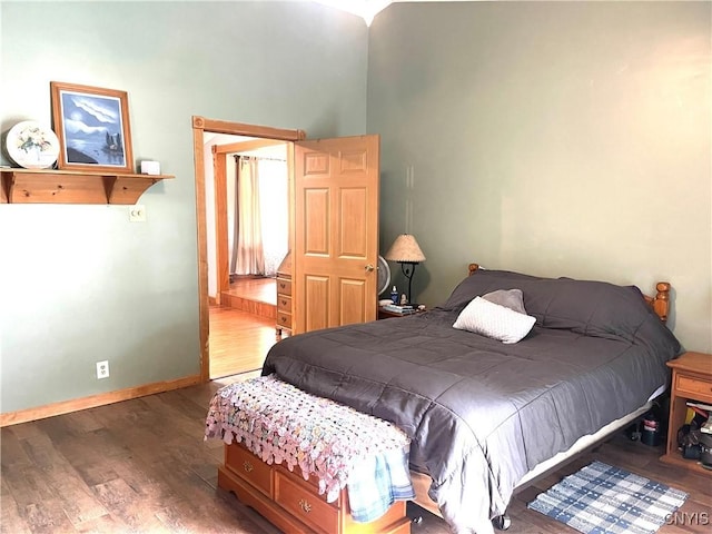 bedroom featuring baseboards and wood finished floors