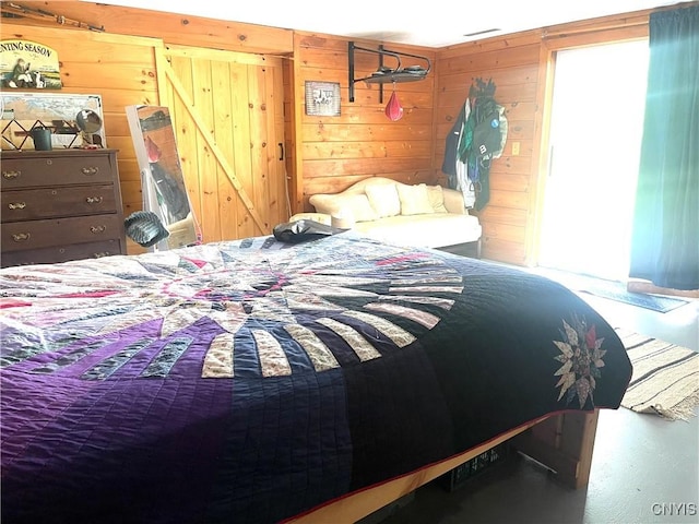 bedroom featuring visible vents and wood walls