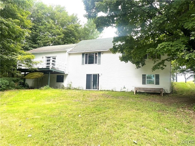 rear view of house featuring a lawn