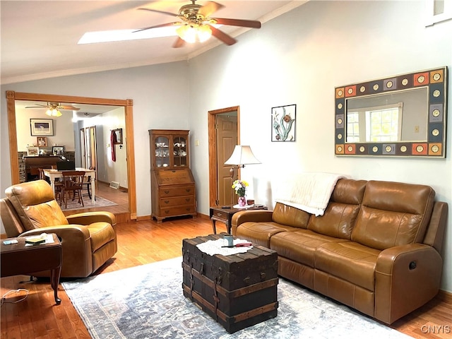 living room with ceiling fan, high vaulted ceiling, ornamental molding, and hardwood / wood-style floors