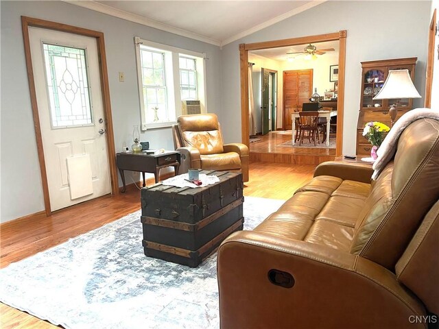 living room featuring ceiling fan, crown molding, lofted ceiling, and light hardwood / wood-style floors