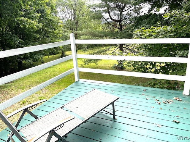 wooden terrace with a lawn