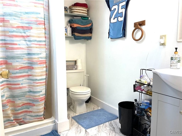 bathroom featuring toilet, marble finish floor, curtained shower, baseboards, and vanity