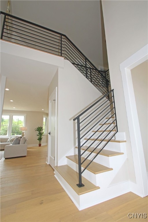 staircase featuring wood-type flooring