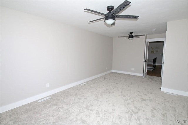 interior space featuring visible vents, baseboards, light colored carpet, and ceiling fan