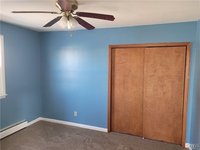 unfurnished bedroom with ceiling fan, a closet, carpet, and a baseboard heating unit