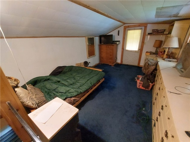 bedroom featuring lofted ceiling and carpet floors