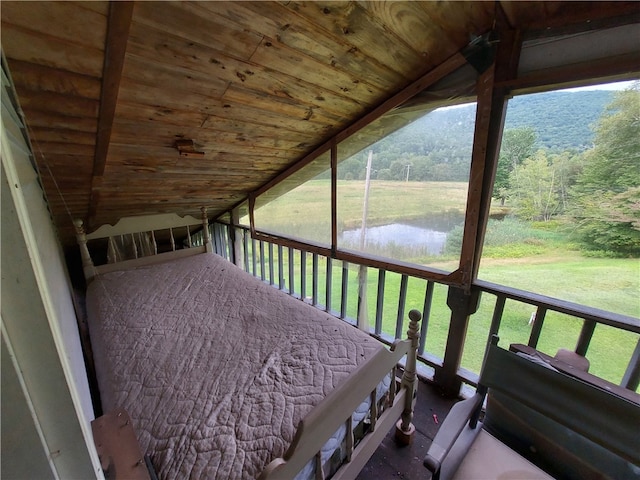 exterior space with vaulted ceiling, a healthy amount of sunlight, and a water view