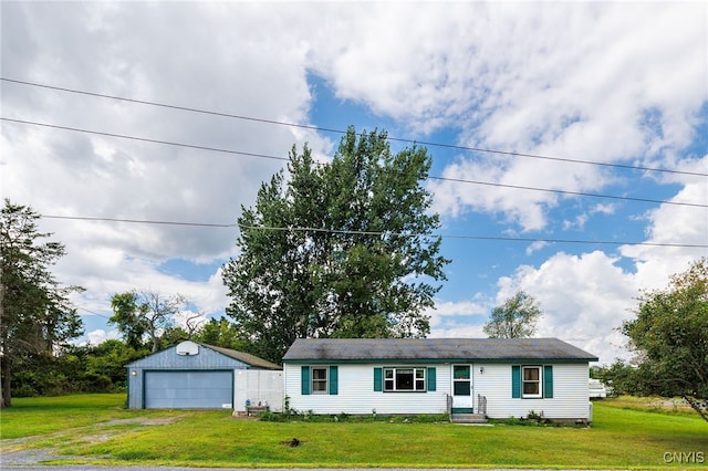 single story home with a garage, a front yard, and an outdoor structure