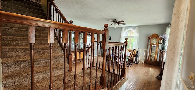 interior space with ceiling fan, hardwood / wood-style flooring, and a textured ceiling