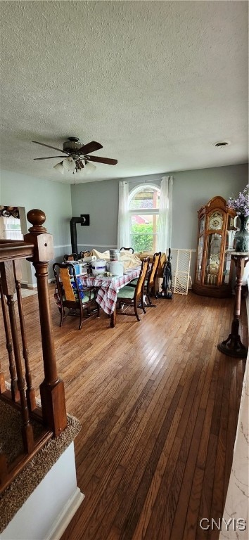 dining area featuring ceiling fan, a textured ceiling, and hardwood / wood-style flooring