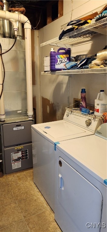 laundry area featuring light tile patterned flooring and separate washer and dryer