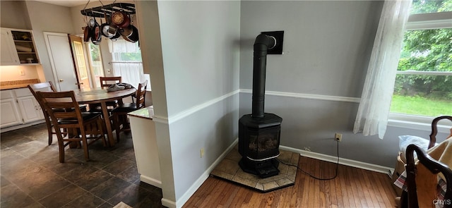 interior space featuring a healthy amount of sunlight and a wood stove