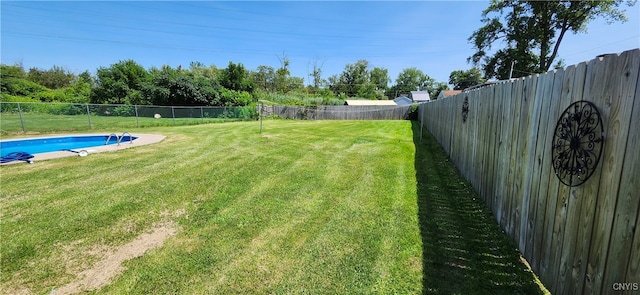 view of yard with a fenced in pool