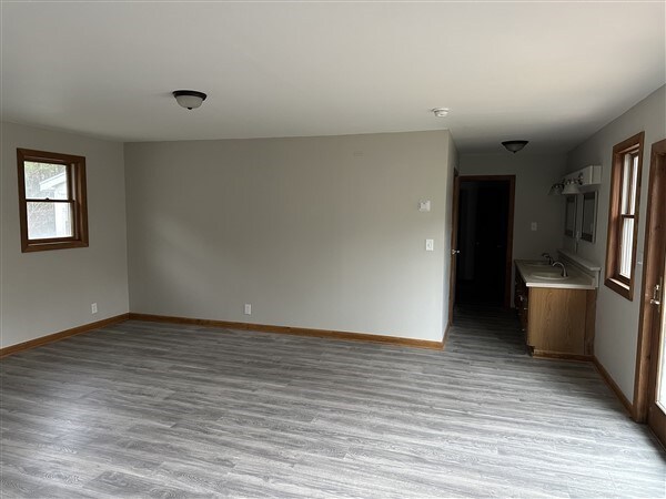 empty room with sink and light wood-type flooring