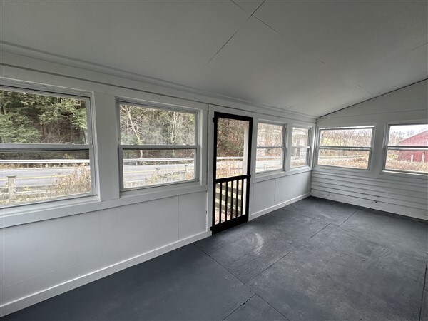 unfurnished sunroom with vaulted ceiling