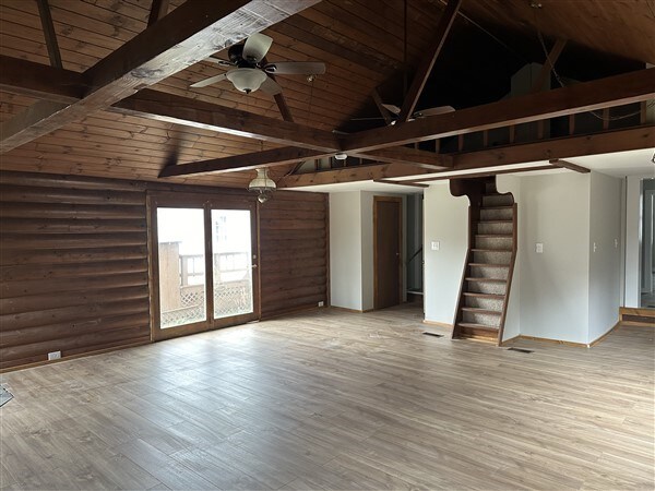 unfurnished room with hardwood / wood-style flooring, wooden ceiling, high vaulted ceiling, and beamed ceiling