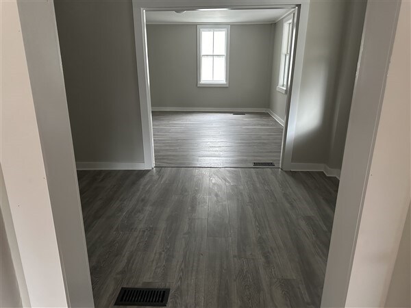 unfurnished room with dark hardwood / wood-style floors