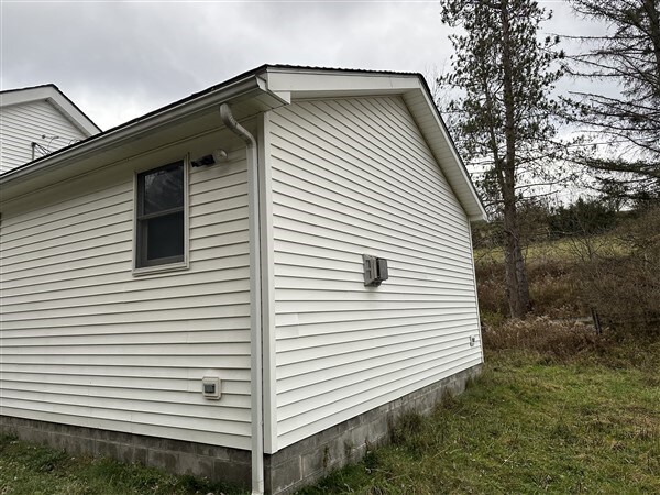 view of side of home featuring a yard