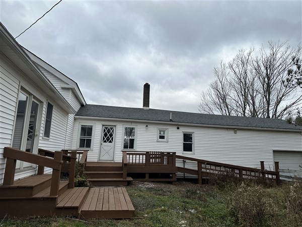 back of property featuring a wooden deck