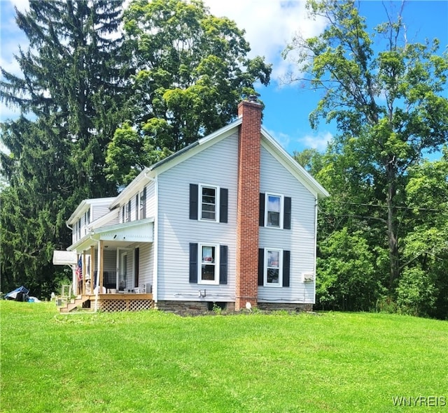 exterior space featuring a front lawn and covered porch