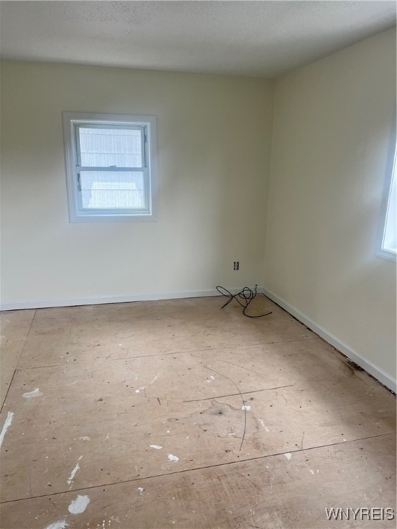 spare room with a textured ceiling