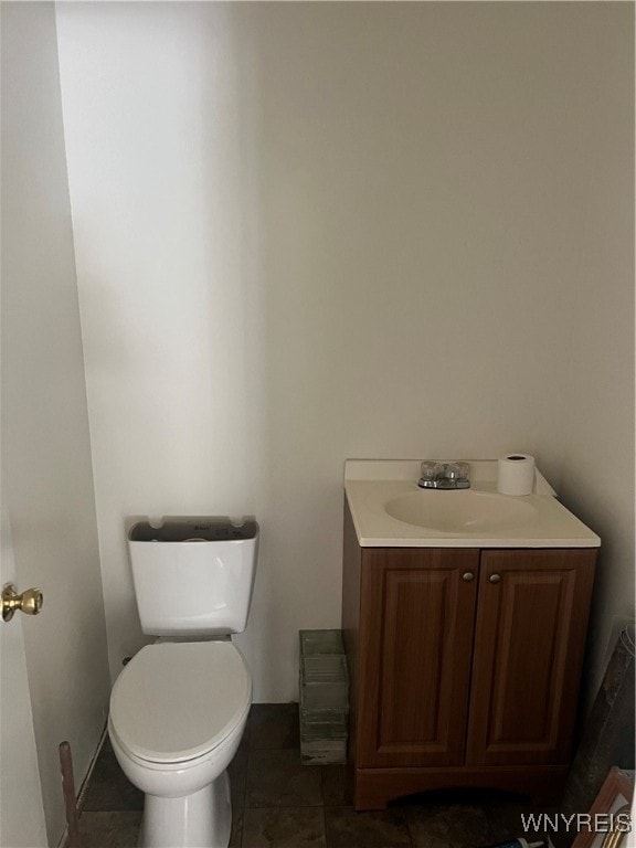 bathroom featuring vanity, tile patterned flooring, and toilet