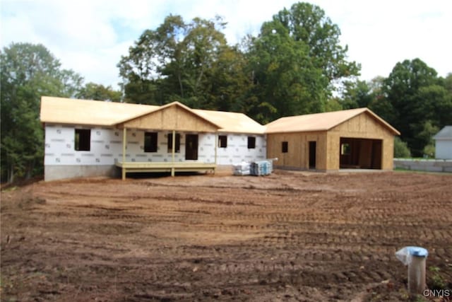 view of front facade with a garage and an outbuilding