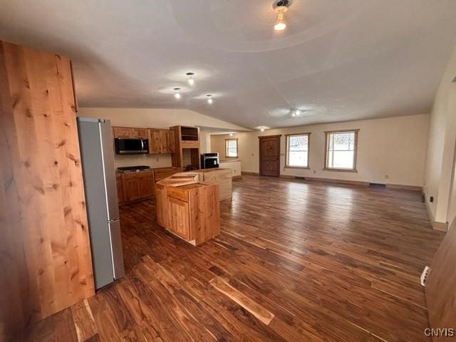 96 Slosson Rd, West Monroe, NY 13167 - kitchen featuring vaulted ceiling, dark wood-type flooring, baseboards, appliances with stainless steel finishes, and open floor plan