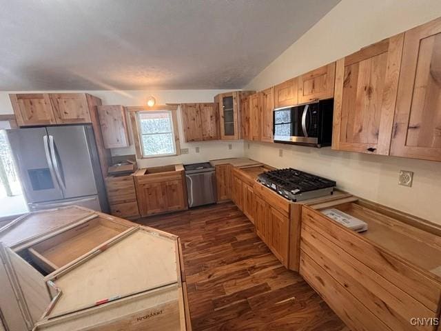 kitchen featuring dark wood-style flooring, stainless steel refrigerator with ice dispenser, lofted ceiling, glass insert cabinets, and dishwashing machine