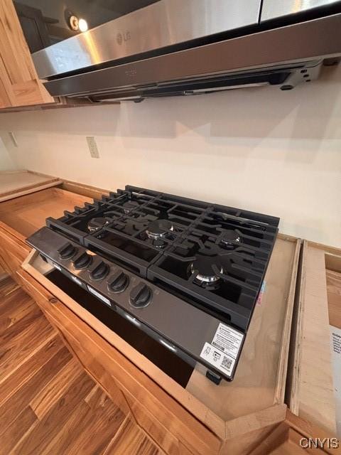 96 Slosson Rd, West Monroe, NY 13167 - details featuring black stovetop, wood finished floors, and ventilation hood