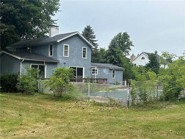 rear view of property with a yard