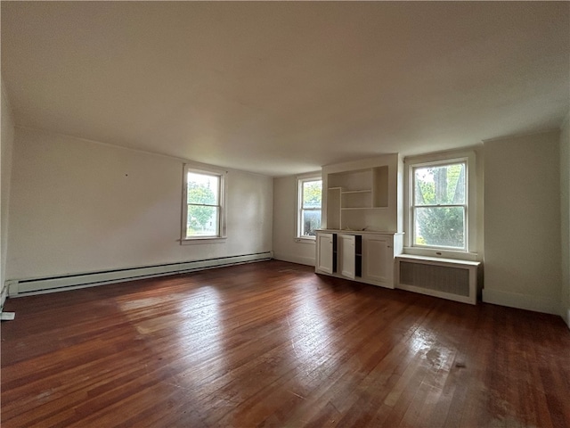 unfurnished living room with radiator heating unit, dark hardwood / wood-style floors, and a baseboard heating unit