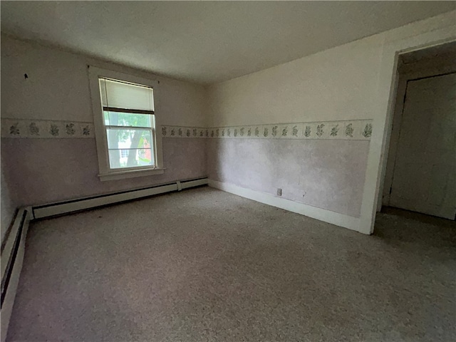 unfurnished bedroom with a baseboard heating unit