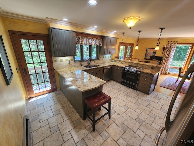 kitchen featuring stove, kitchen peninsula, sink, and a wealth of natural light