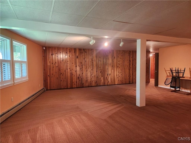 1666 Buffs Blf, Skaneateles, NY 13152 - basement featuring track lighting, a baseboard heating unit, carpet floors, and wood walls